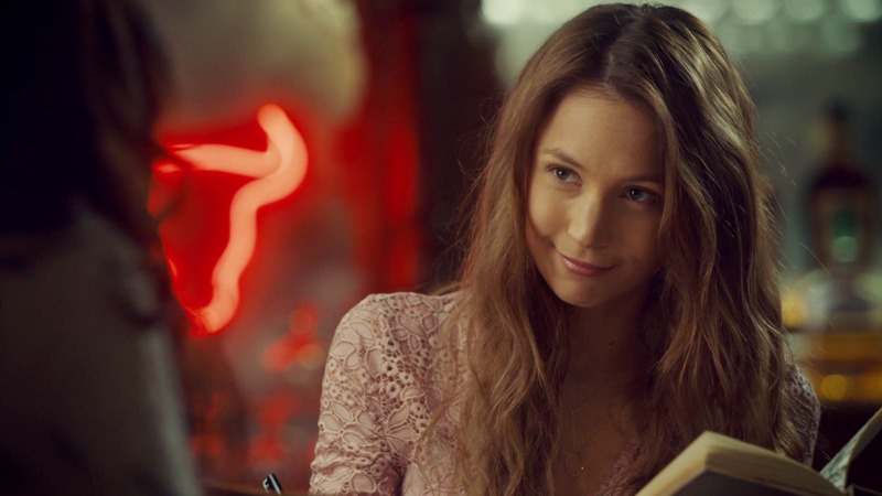 Waverly is reading an old book and smirking and looking cute af