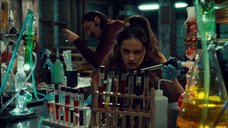 Rosita is holding a turkey baster looking thing over some vials in their little lab