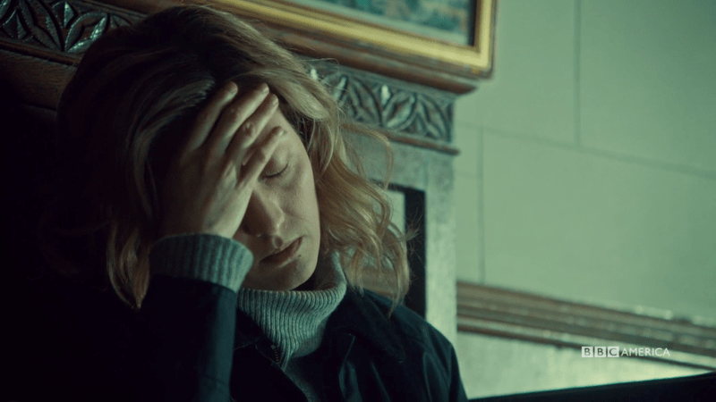 Delphine holds her head in her hand