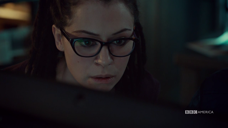 Cosima looks surprised at her computer