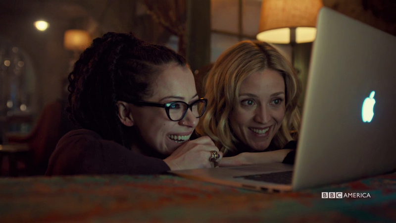 Cosima and Delphine smile so giddily at their computer