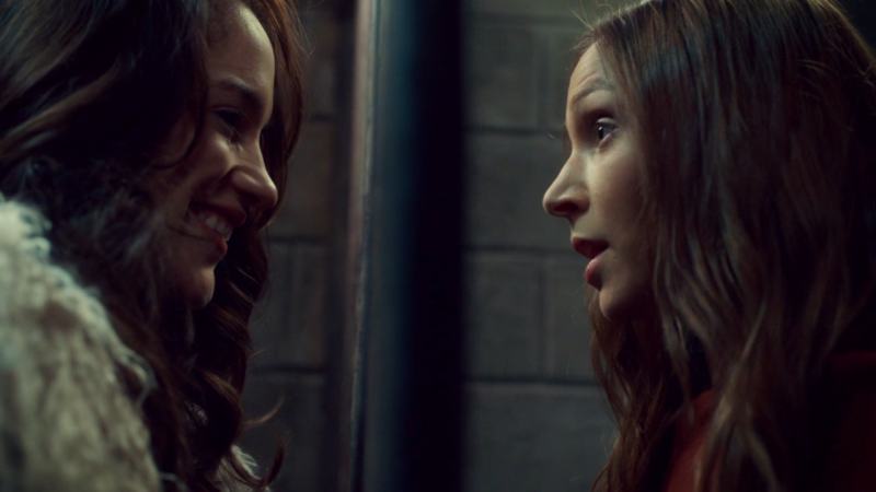 Waverly leans in toward Goononna who is still behind bars