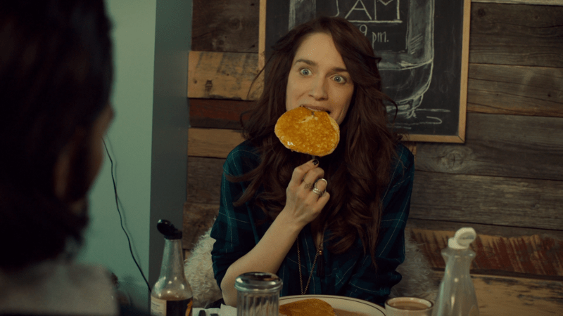 Wynonna shoves a giant pancake in her mouth.