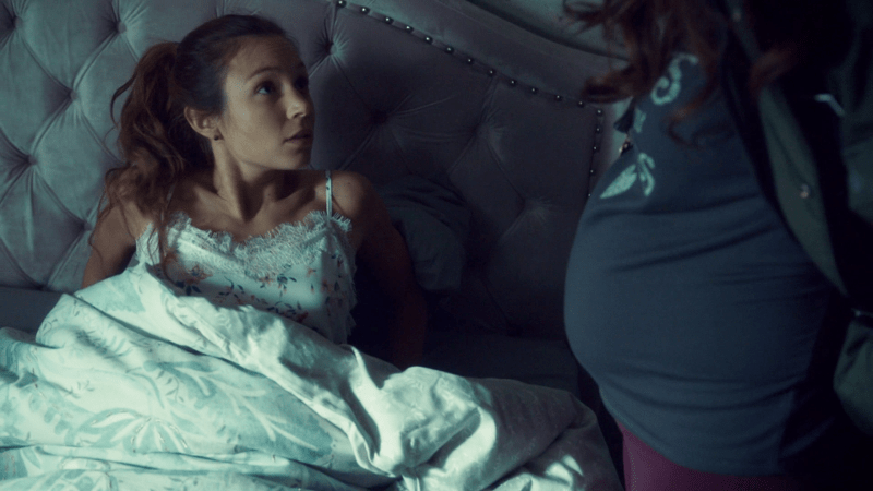 Waverly looks startled as she's woken up and eye to eye with Wynonna's baby bump