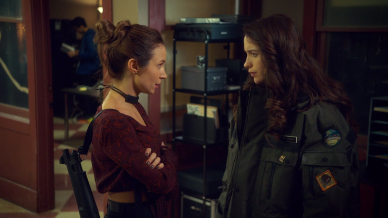 Waverly and Wynonna are talking and Waverly has a shotgun on her back