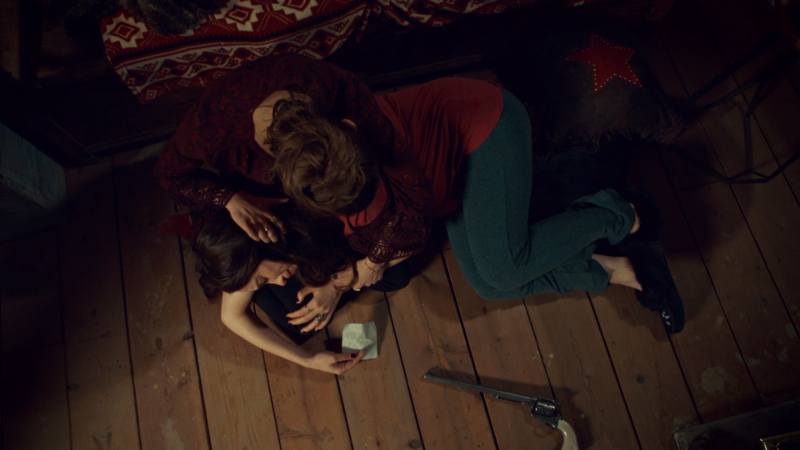 Wynonna cries on Waverly's lap with the note and Peacemaker nearby