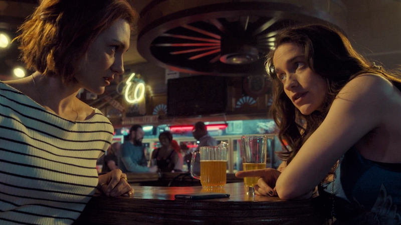 Wynonna and Nicole are deep in conversation at the bar