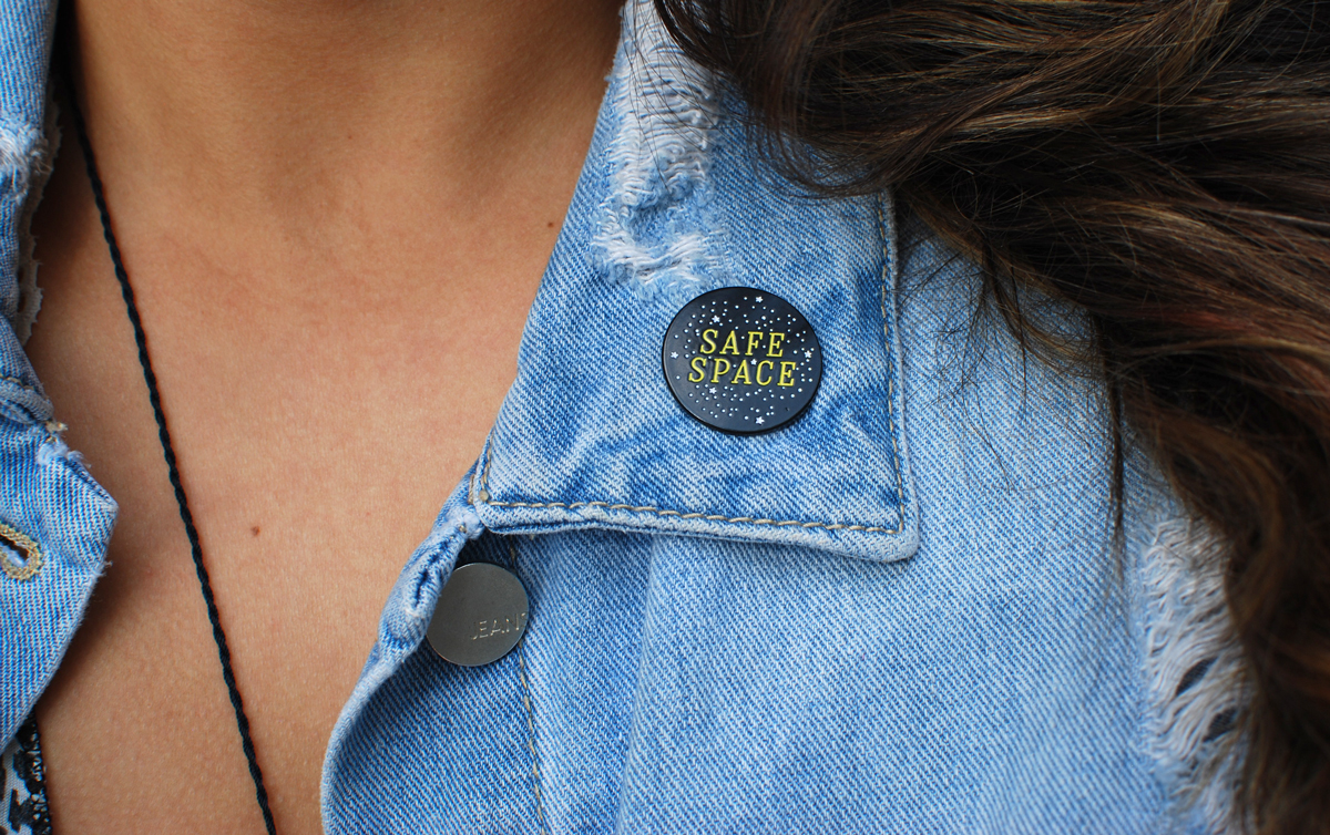Sarah wearing the Safe Space Enamel Pin on denim jacket