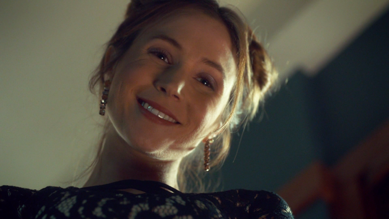 Waverly smiles down at the camera from above, lit like an angel