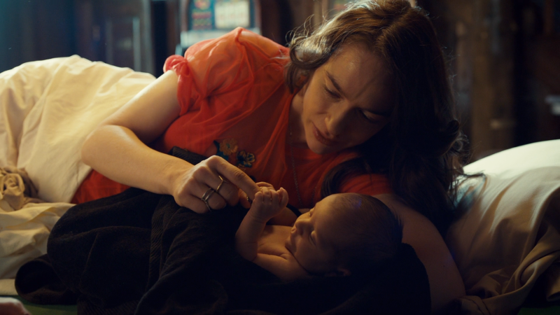 Wynonna plays with the baby's tiny hands