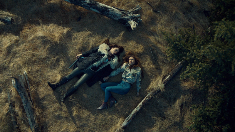Wynonna and Waverly lie in a field 