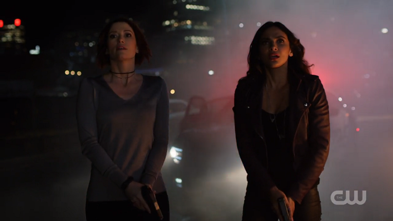 Maggie and Alex look up to the sky as Supergirl flies away