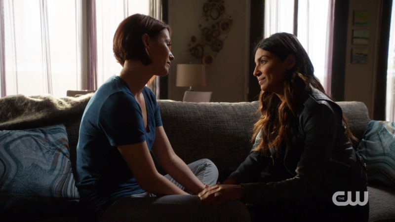 Maggie and Alex look lovingly at each other on the couch