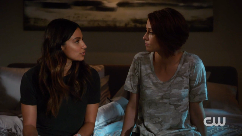 Alex and Maggie sit on the edge of their bed and chat
