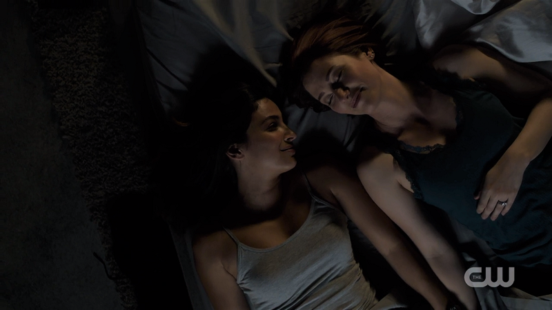 Maggie and Alex lie in bed together