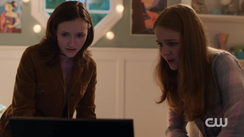Alex and Kara look intensely at their computer