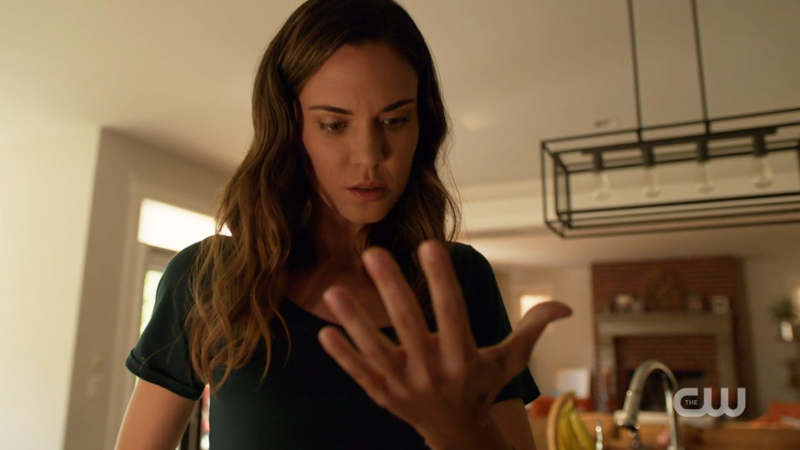 Sam inspects her not-burned hand