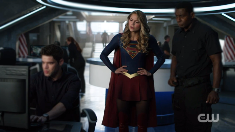 Supergirl stands with her hands on her hips