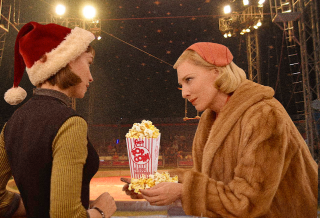 therese and carol at the circus, carol is offering therese some popcorn
