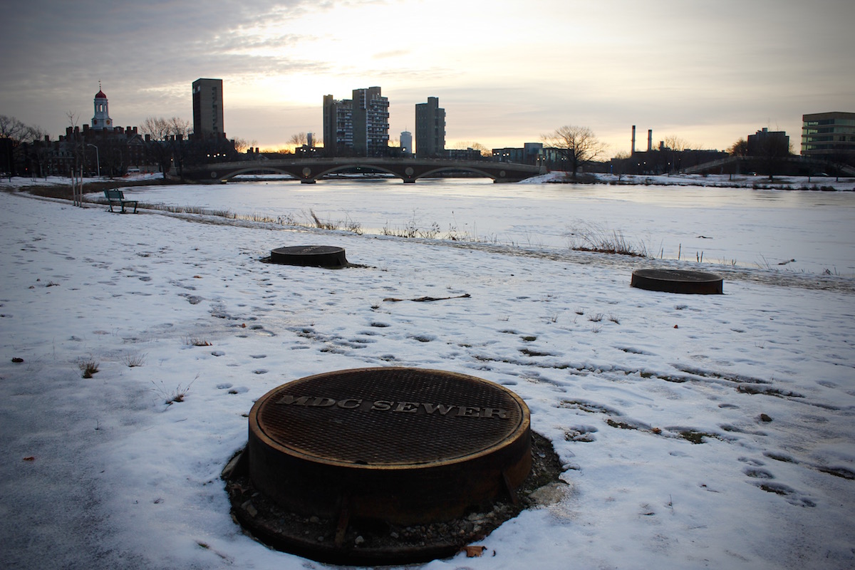 Three sewer manholes near the river.