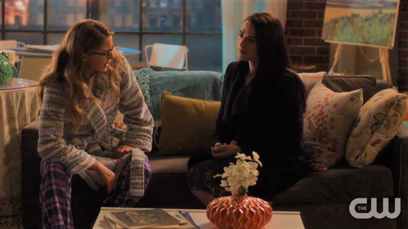 Kara slouches on the couch next to Lena