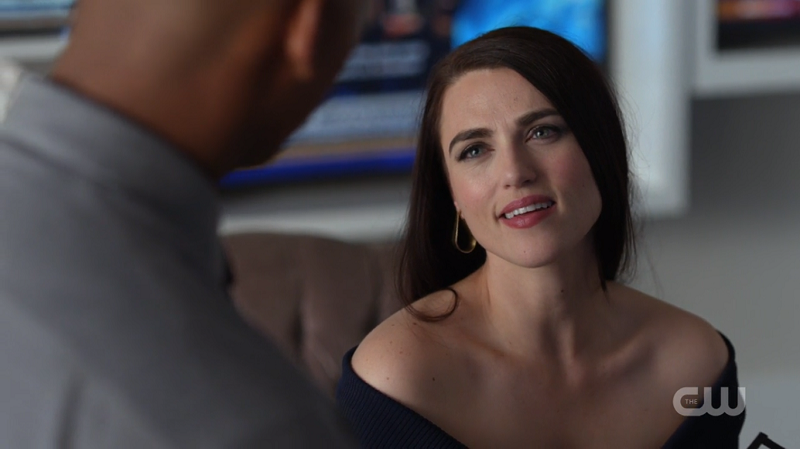 Lena Luthor and her shoulders smile up at James while talking about Kara