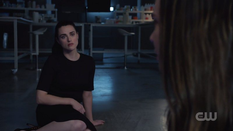 Lena sits outside Sam's containment unit