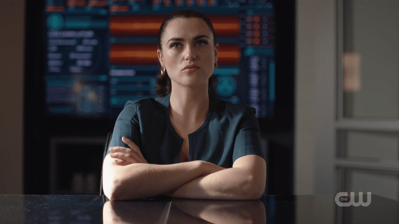 Lena crosses her arms while she is interrogated by Team Supergirl 