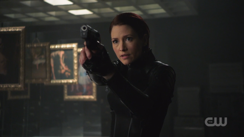 Alex and her new suit and short hair are pointing a gun and i hate guns in real life but this look is a good one