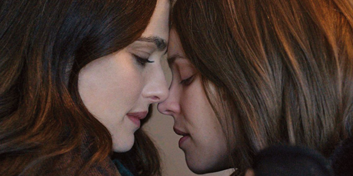 Rachel Weisz touching heads with Rachel McAdams in Disobedience