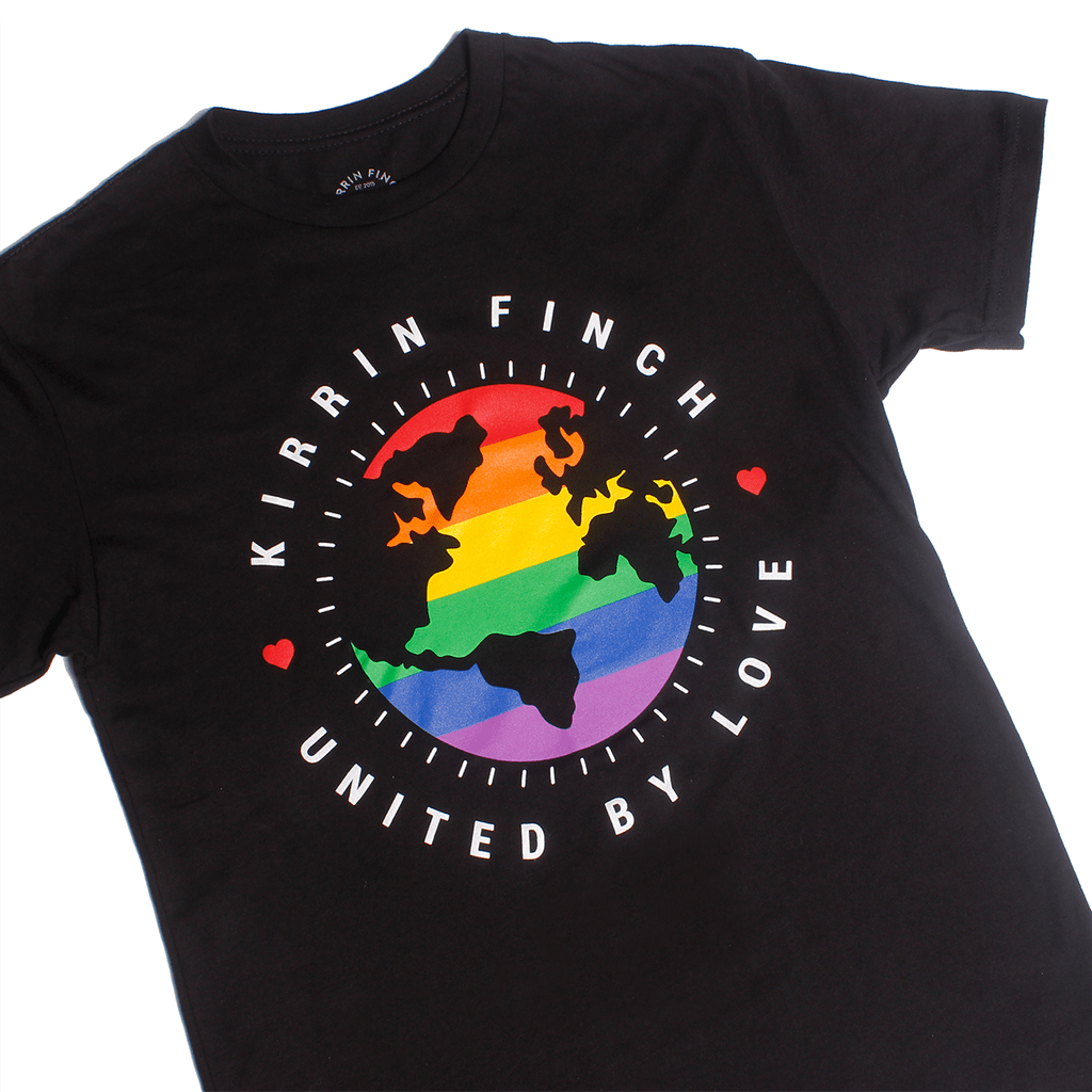 black t-shirt with globe logo in a rainbow gradient, the words "Kirrin Finch United By Love" looped around it
