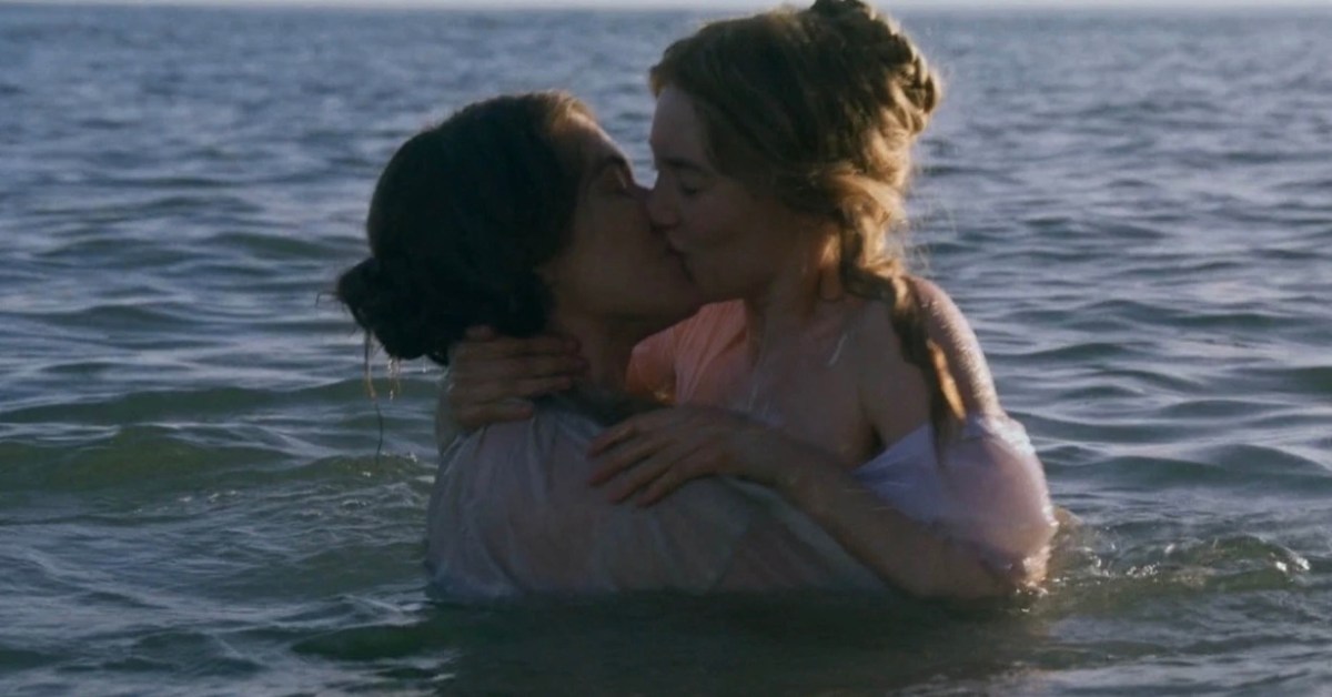 Kate Winslet and Saoirse Roman making out in the ocean in "Ammonite"