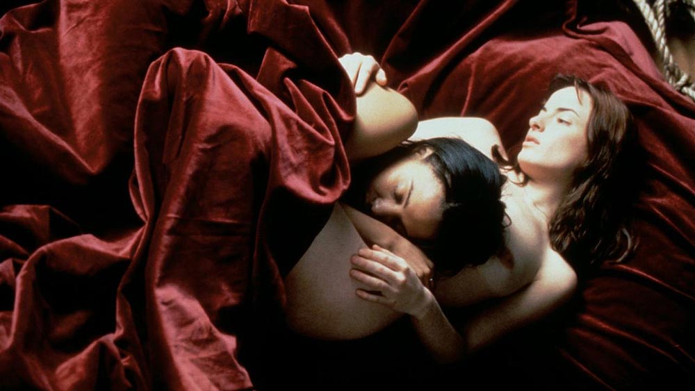 Still of two women naked in bed together from "When Night is Falling"