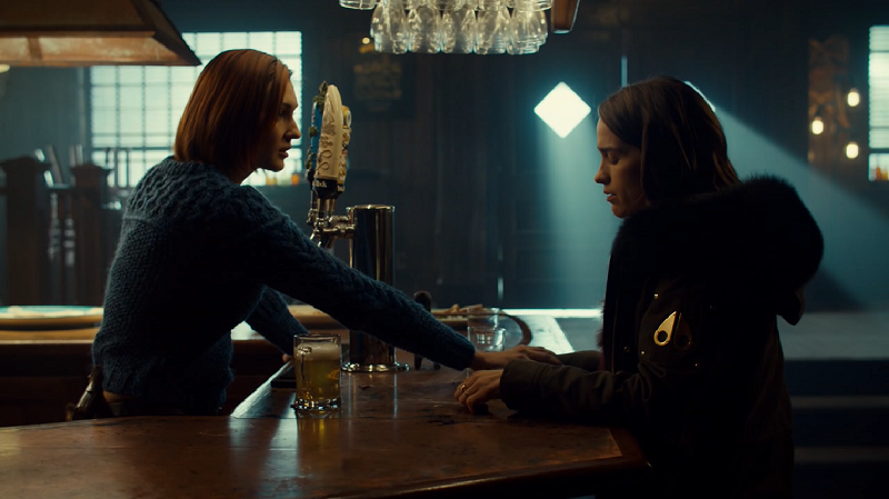 Nicole reaches over the bar to hold Wynonna's hand