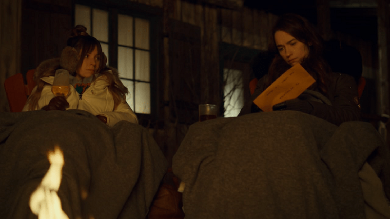 Waverly and Wynonna sit by the fire opening the envelope