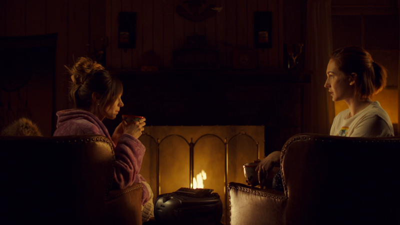 Waverly and Nicole sit by the fire