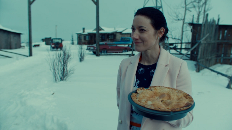 Jolene stands innocently holding a pie