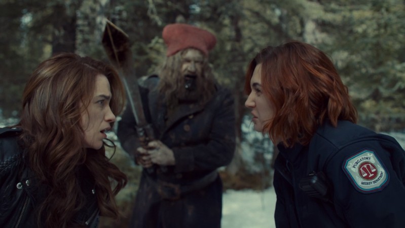 Wynonna and Nicole exchange ruh roh glances about the gnome man