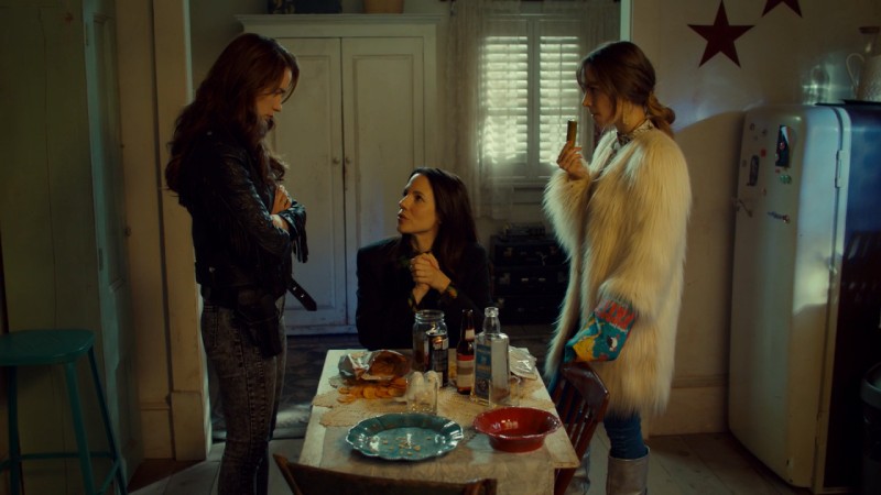 Waverly and Wynonna talk to Kevin while eating a pickle