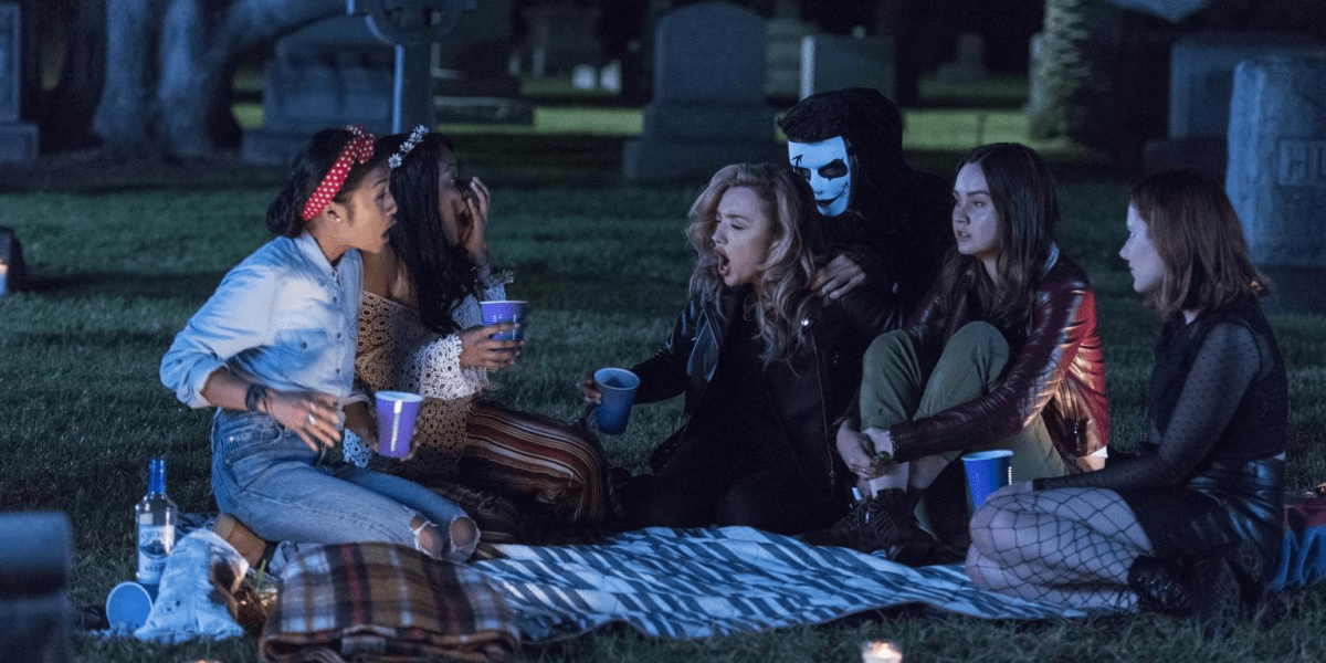 Light as a Feather still: girls with candles in a spooky scenario