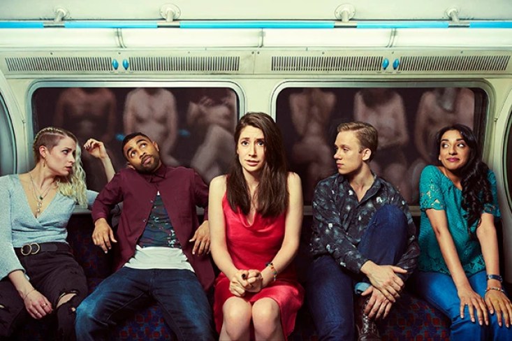 Pure cast sitting on a subway trian