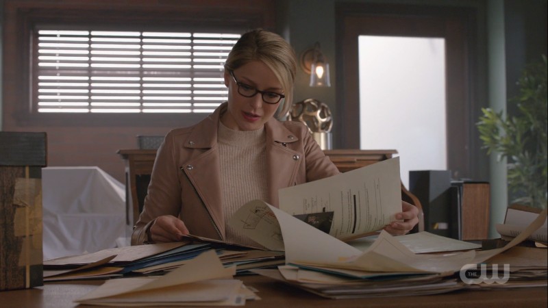 Kara looking through papers