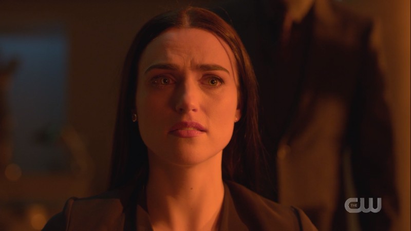 Lena looks stressed and washed in red light