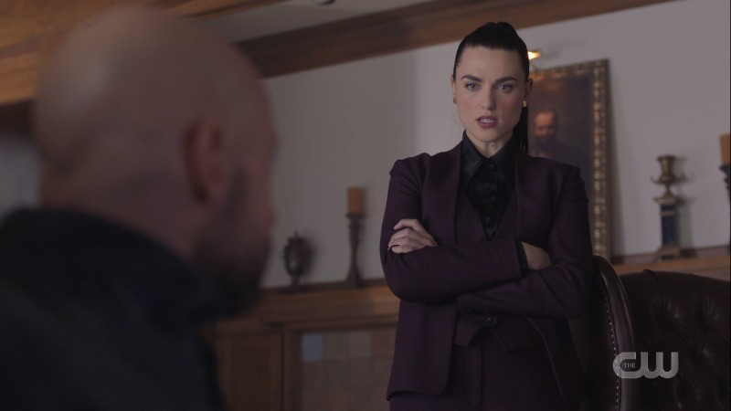 Lena in a suit crossing her arms