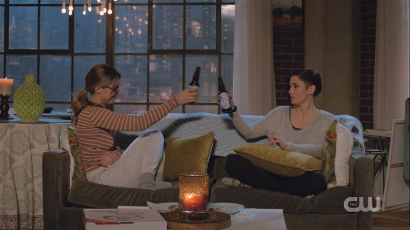 Danvers sisters cheers beer bottles on the couch