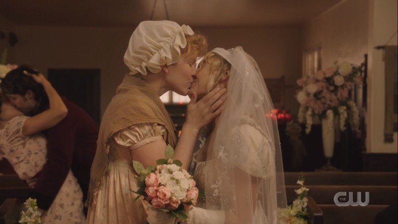 The bride and the scullery maid kiss