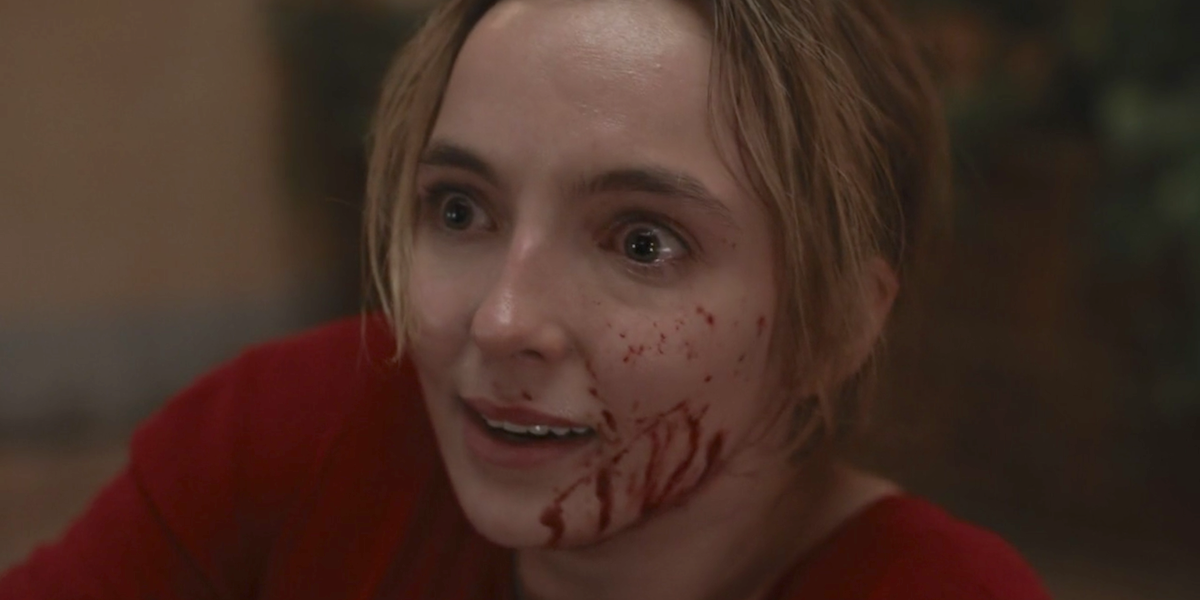 Villanelle (Jodie Comer) has a wide eyed expression and blood on her face