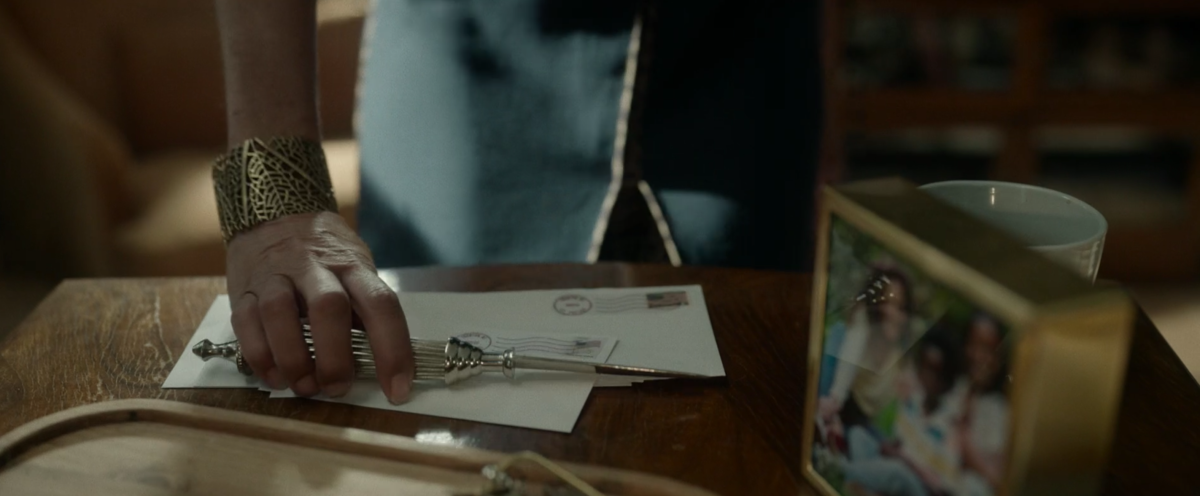 Taissa grabs a letter opener