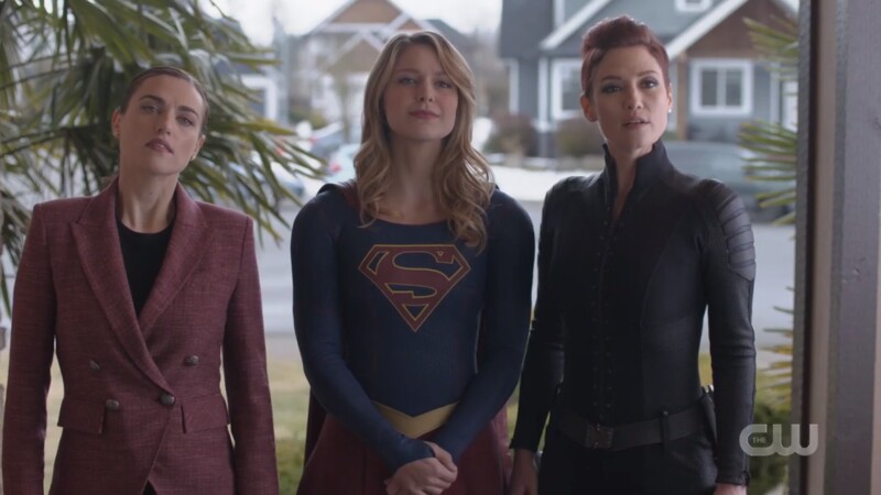 Dr. Lena Luthor, Supergirl, and Director Alex Danvers stand in the doorway togethr