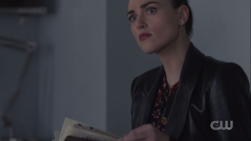 Lena looks up startled from the journal she's reading